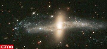 کهکشان نادری که در نوار کیهانی رمزآلود پیچیده شده